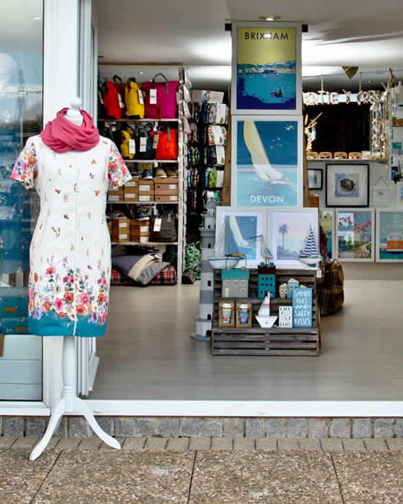 Bertie and Crew shopfront on Prince William Quay at Brixham Marina, with the harbour behind.
